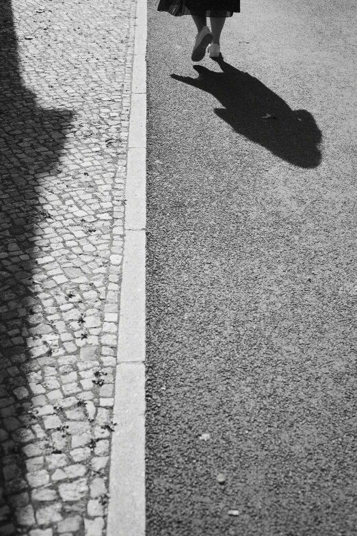 a woman in a dress is walking on the street