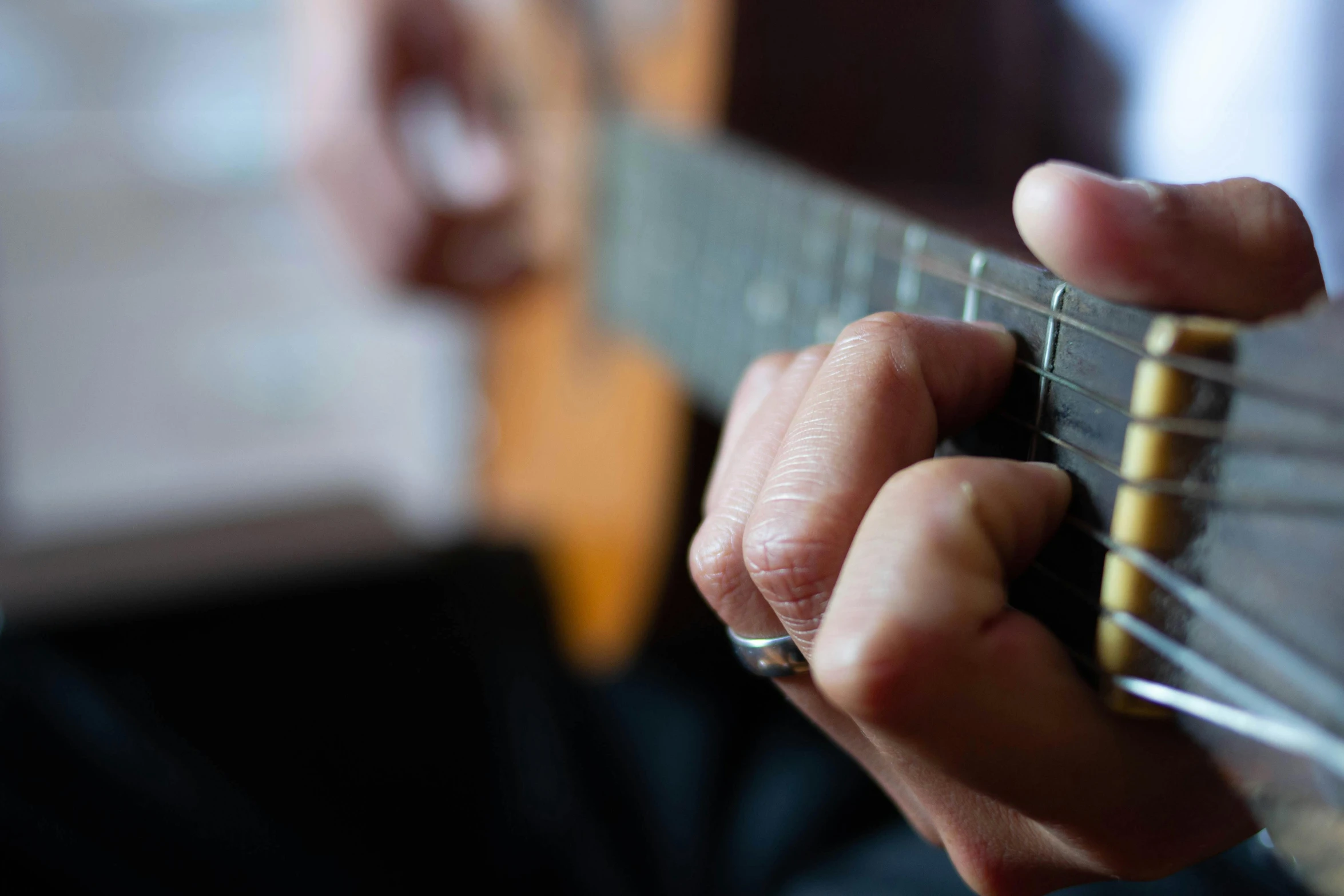 a man holding onto a small guitar string