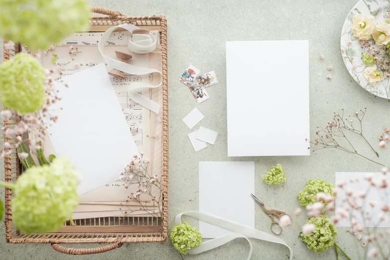 flowers and craft items laying around a piece of paper