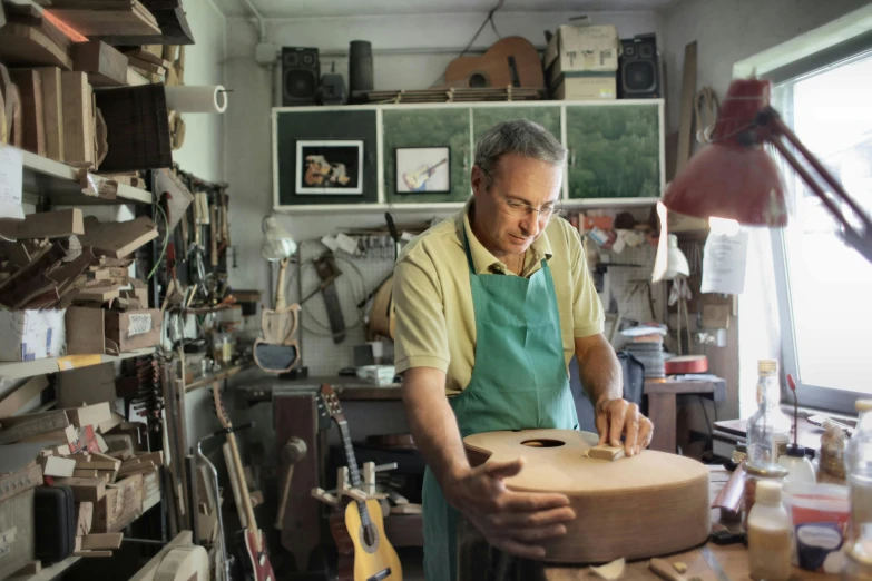 a man working with a pottery wheel inside