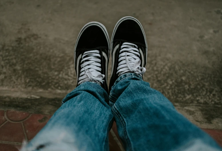 a person wearing white shoes on their feet