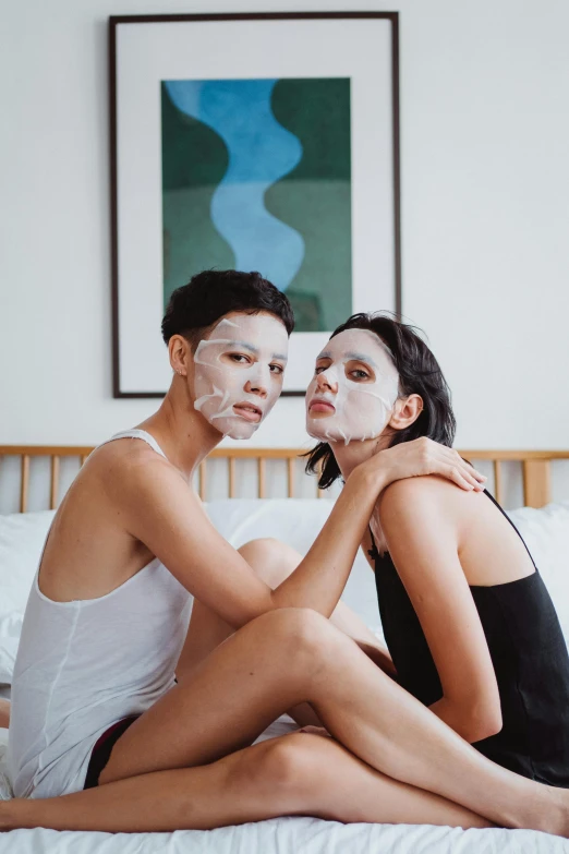 woman and man are in a white bathroom on the bed