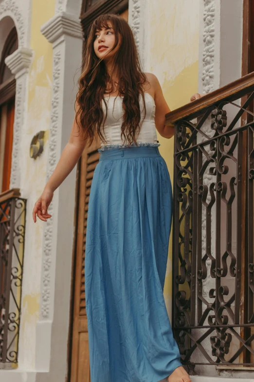 a young woman standing on the stairs of her home