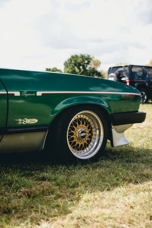 closeup of the wheels on an old green car