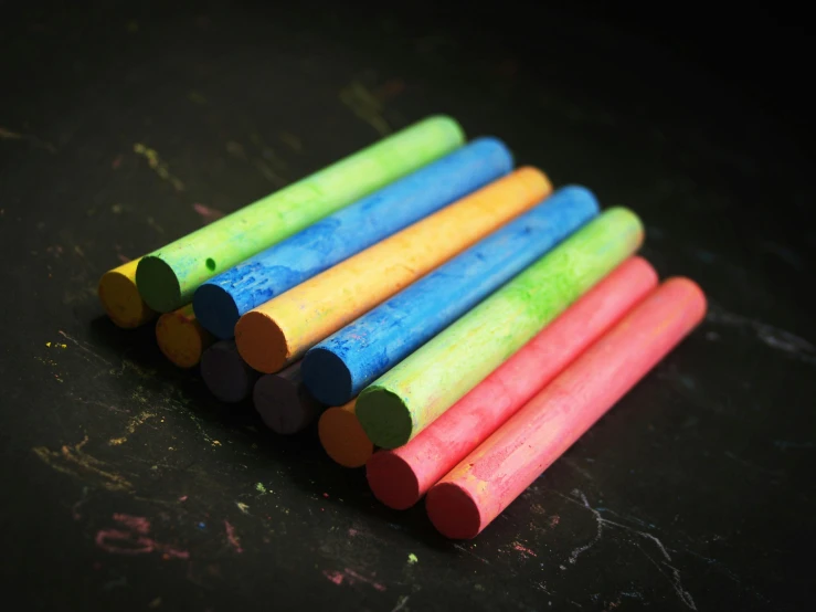 several colored sticks of various sizes in a row