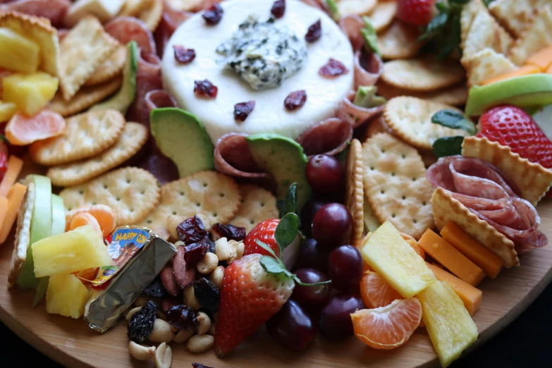 a plate of various fruits, vegetables and ers on a table