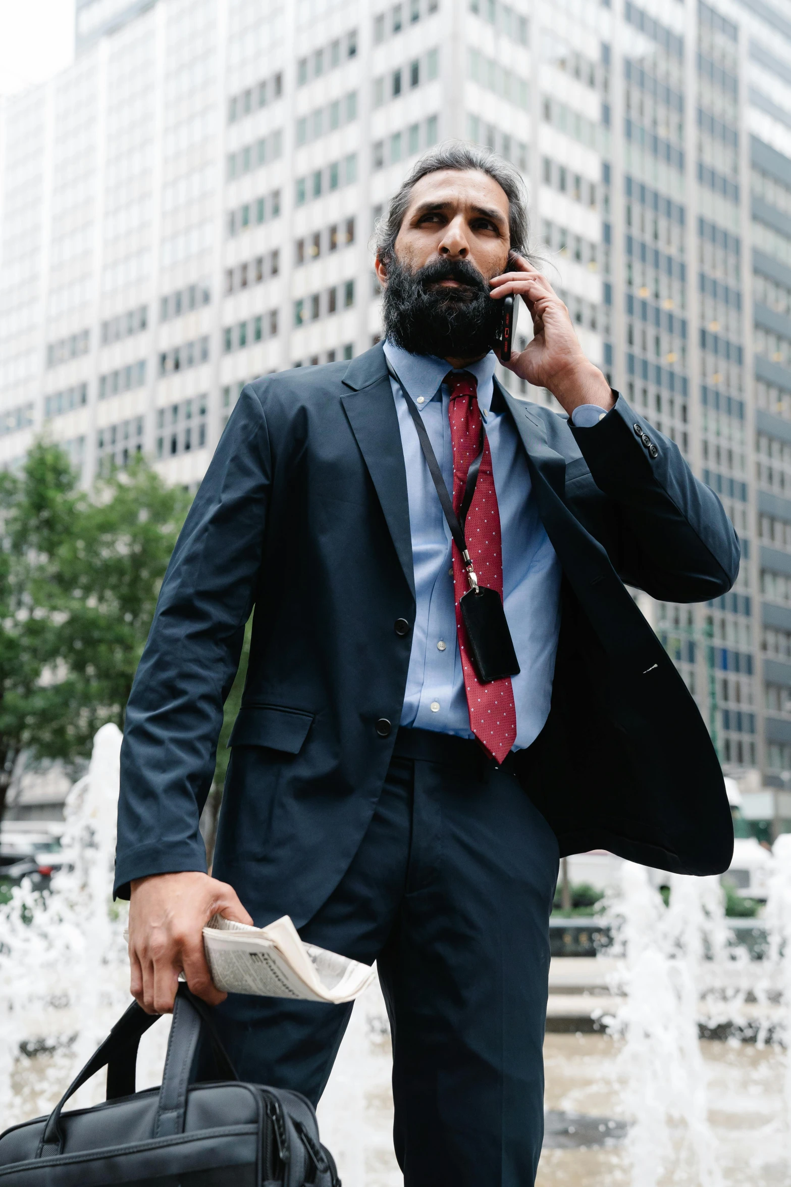 a man in a suit talks on the phone