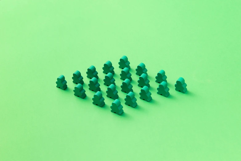 several green legos are set out to form a pyramid