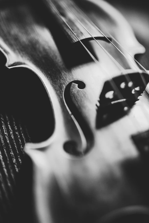 a violin with strings and a black background