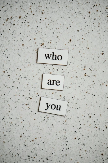 the words who are you on two square tiles