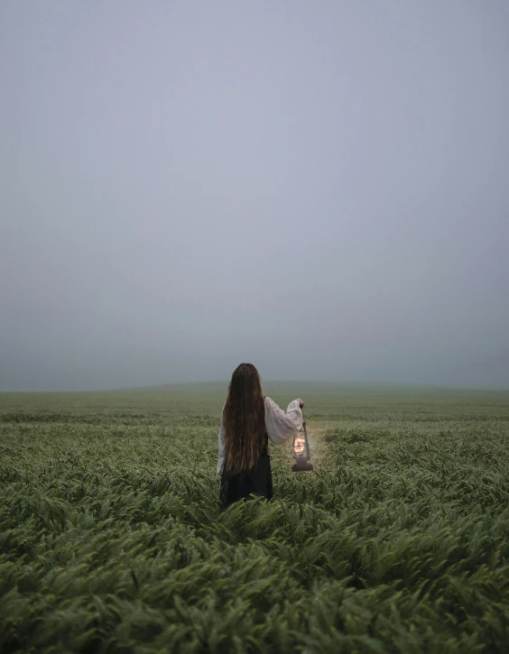 a person in a field holding a bird