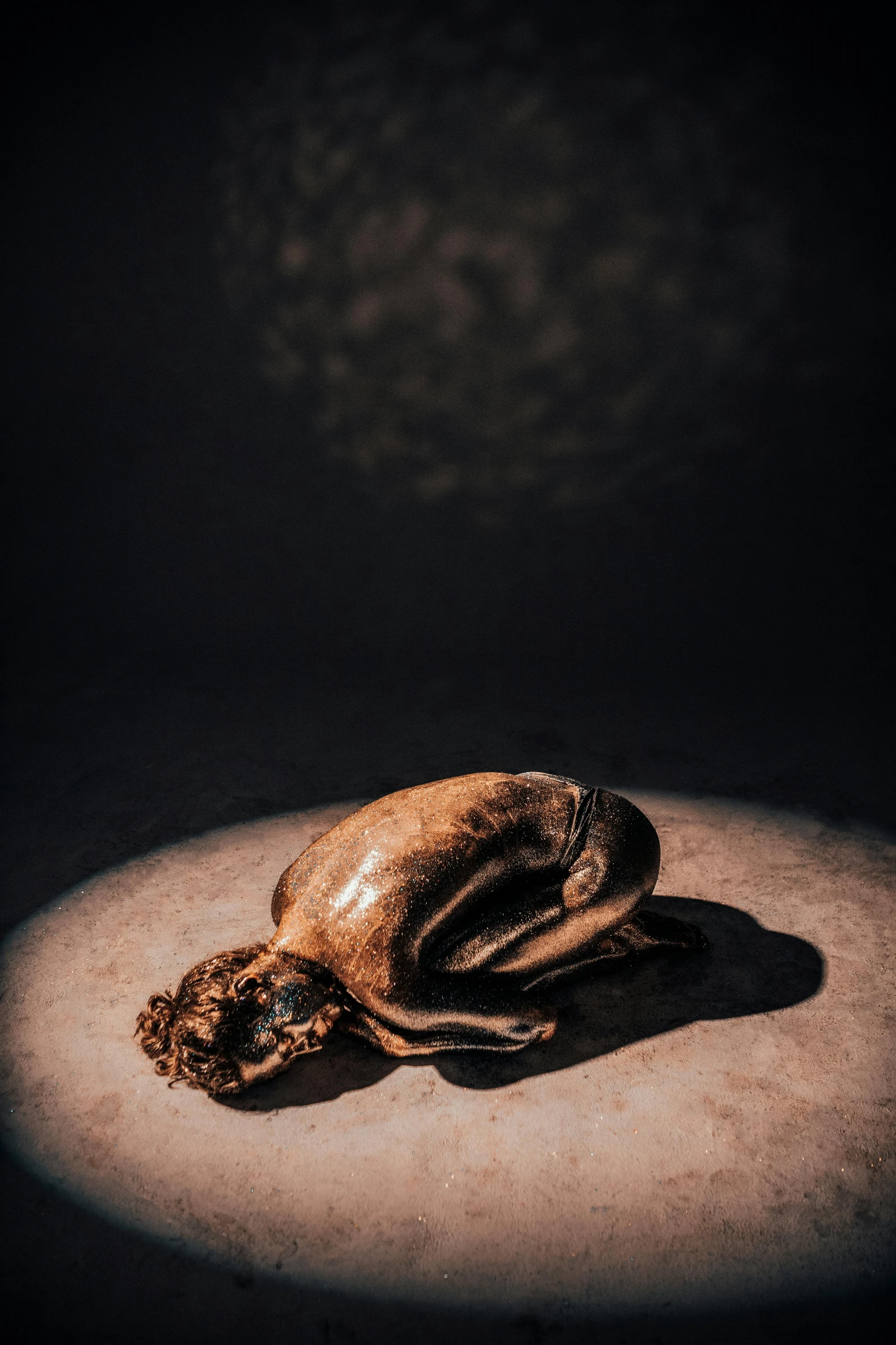 a beetle sitting on top of a table in a dark room