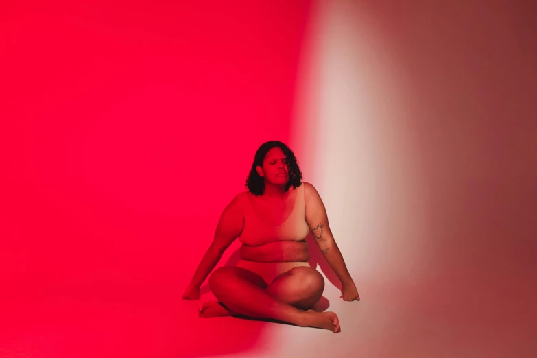 a fat woman squatting on her knees posing for the camera