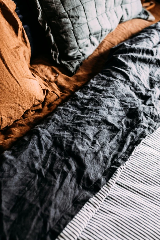 black and white bedding with an orange blanket