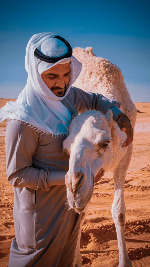 a man is in the desert with a small camel