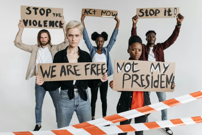 a group of people holding up placards with protest signs