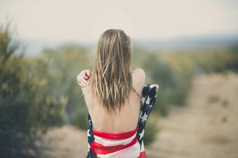 woman with american flag dd over her back