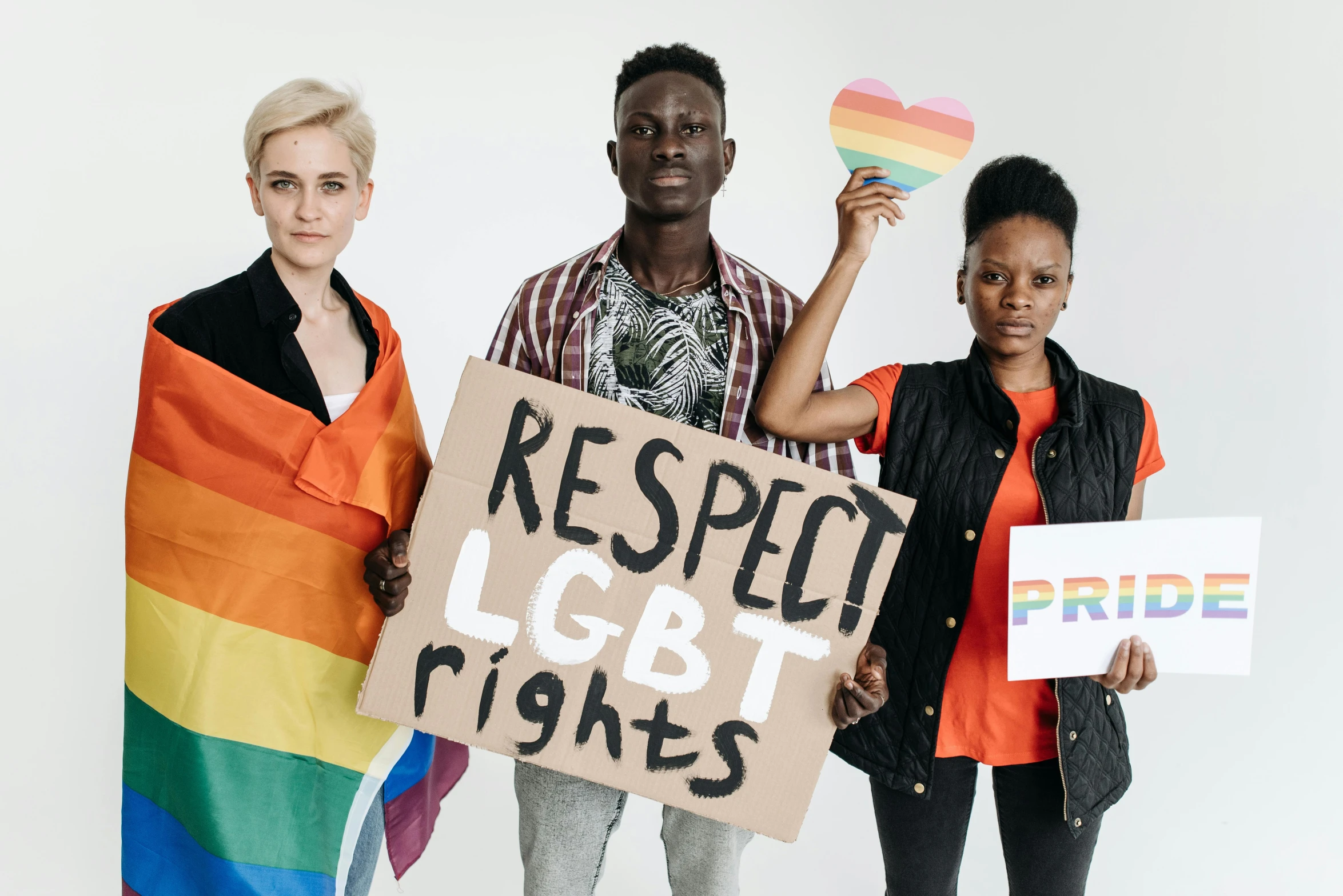 three people holding a sign that says respect lgbt rights