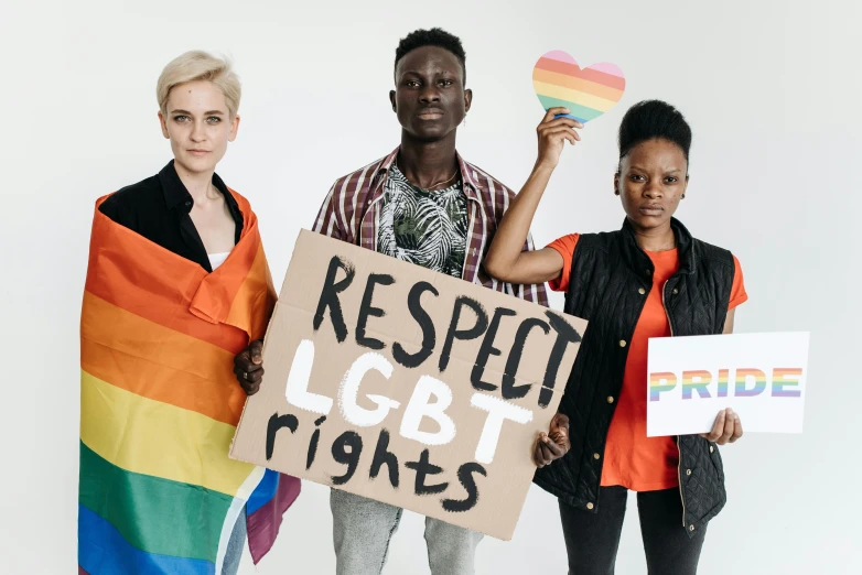three people holding a sign that says respect lgbt rights