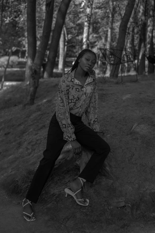 a woman sitting on top of a tree log