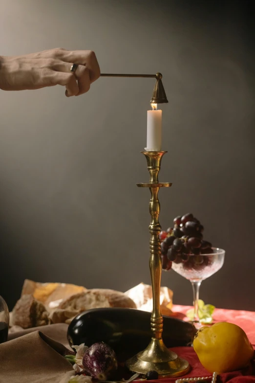 a person is lighting a candle in front of a table