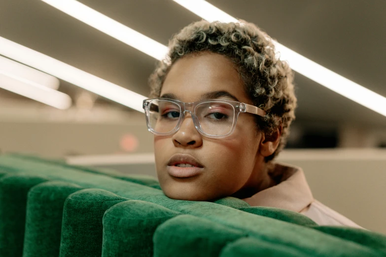 an african american woman wearing clear glasses