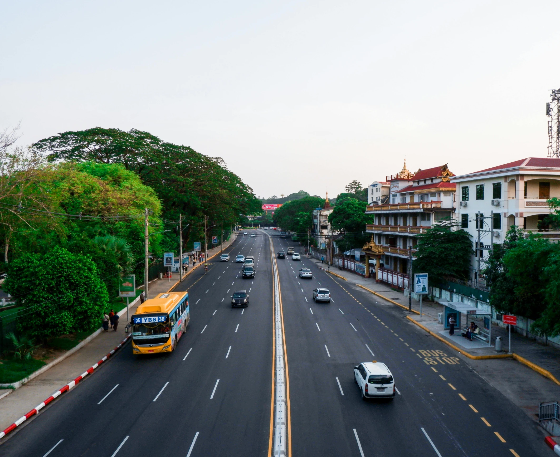 a bus drives down the street near buildings