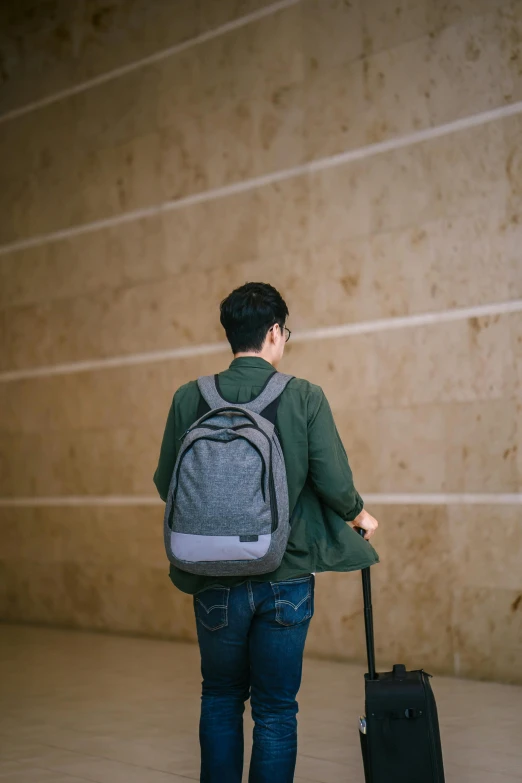 a man with a back pack is standing outside