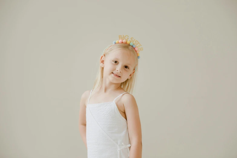 a little girl with a flowered hair crown on her head