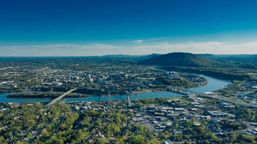 an aerial po with lots of green trees and buildings in the background