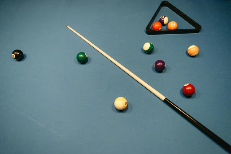 the billiard's pool table has balls and a cue