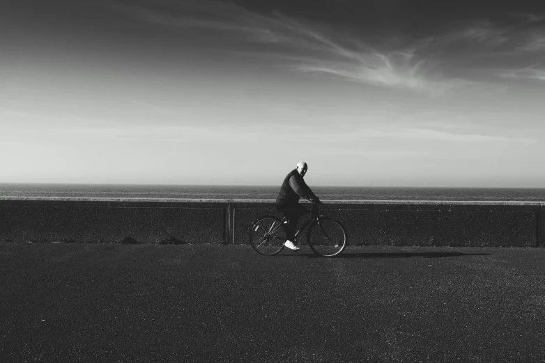 a person riding their bike next to the ocean