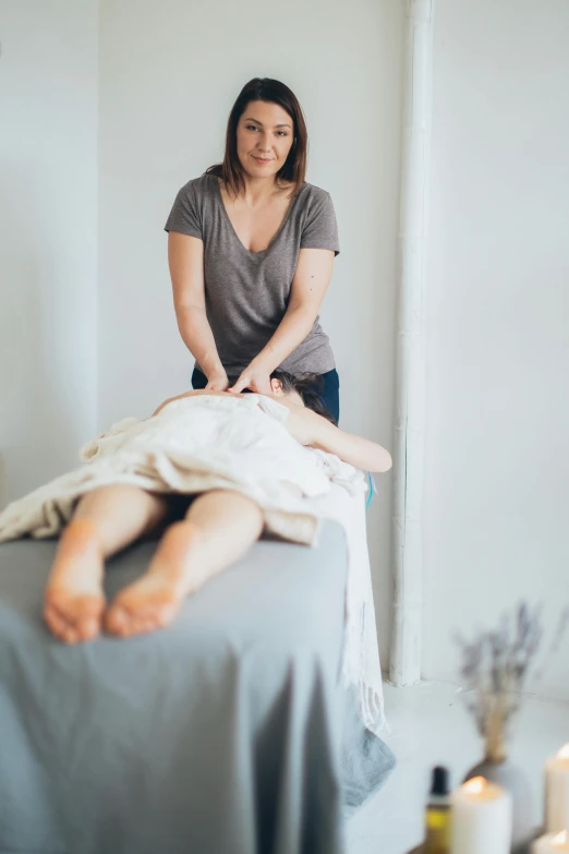 a woman getting her foot massage on a bed