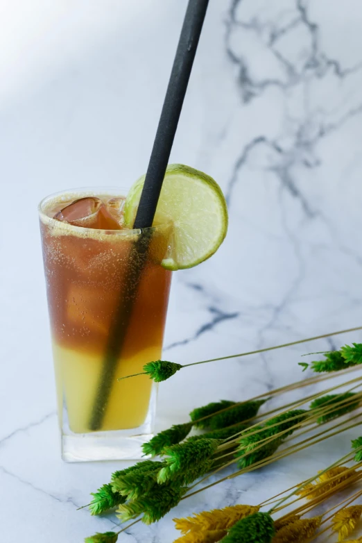 a drink with lime, sugar and ice on a white surface