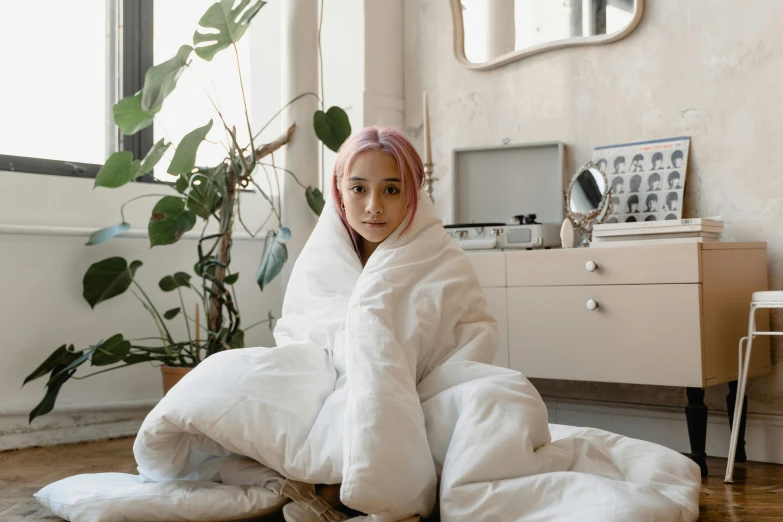 a  in a bathrobe sitting on the floor