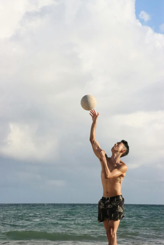 a man is playing frisbee on the beach