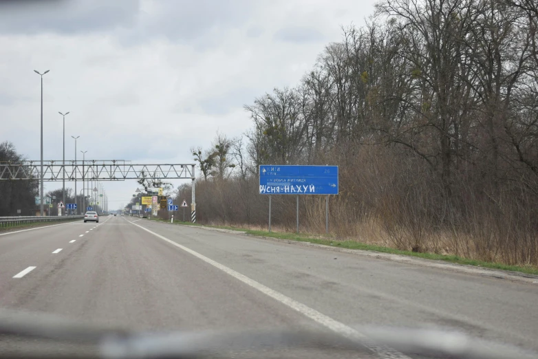 the truck is driving down the road by the bridge