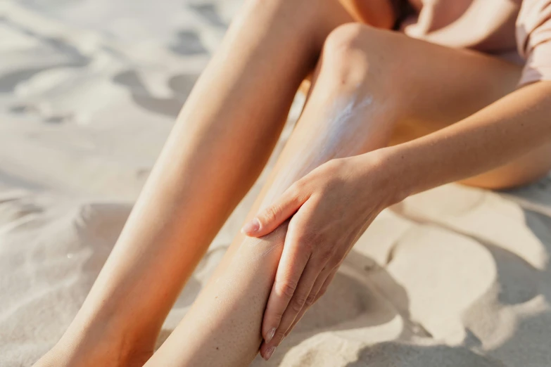 a person sitting in the sand on their toes