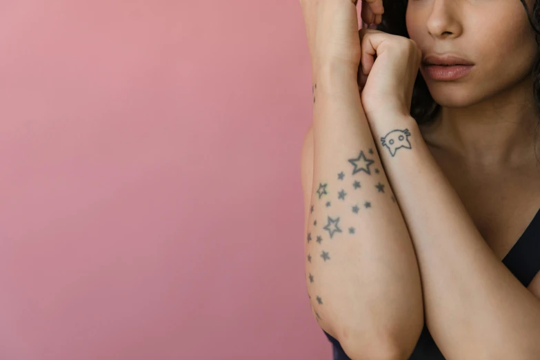 a young woman with tattoos on her arm