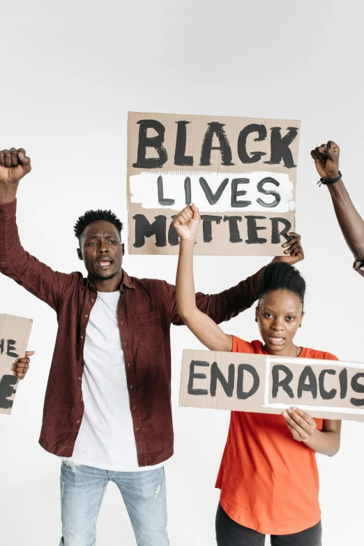 a group of young people holding signs in the air