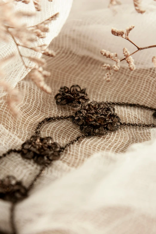 lace, beads and beading on fabric with flower stems