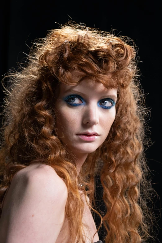 woman with red hair and blue eyes posing