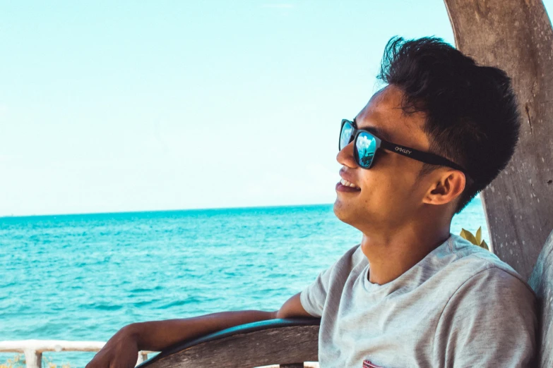 a man sitting in a chair with a view of the ocean