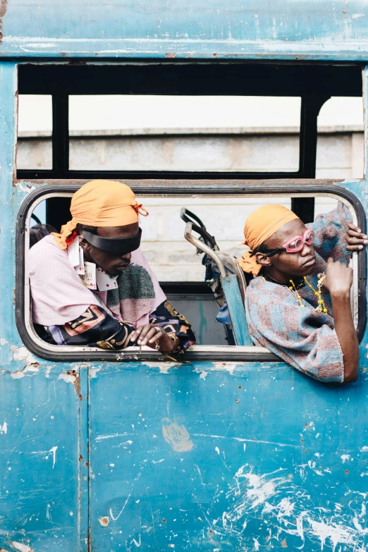 two woman sitting in a bus looking out the window