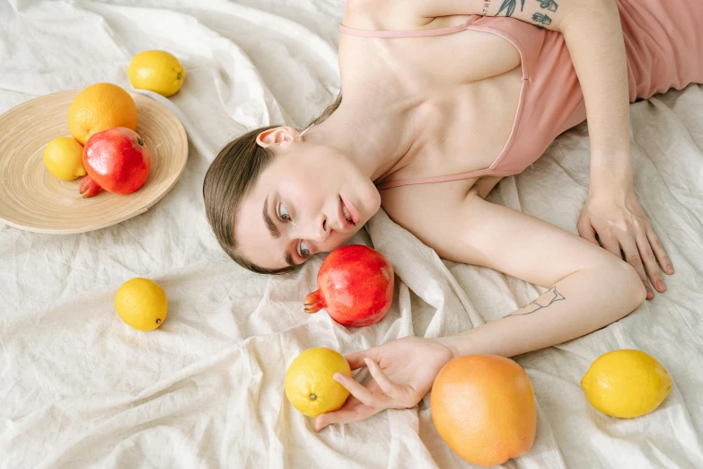 a woman with a bowl of apples and lemons