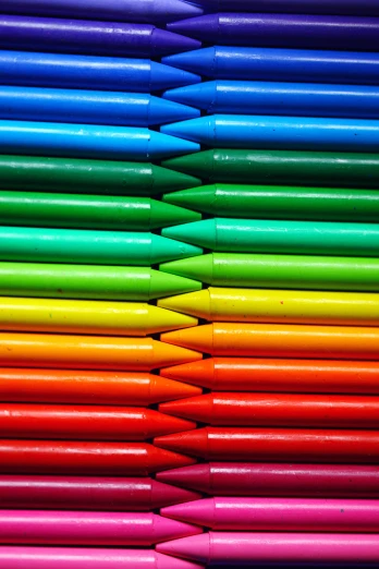 many colored pens lined up in a pyramid