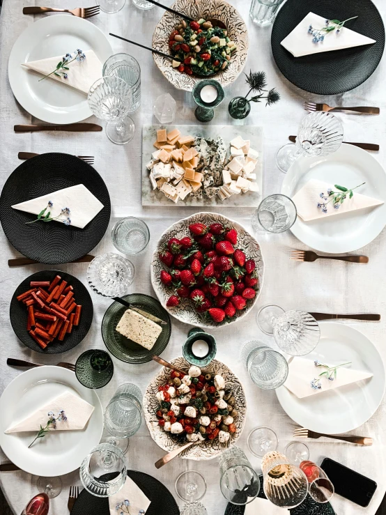 a table topped with lots of plates covered in food