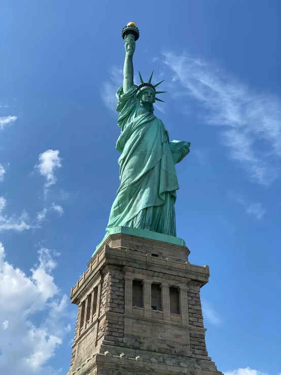 the statue of liberty is seen on a sunny day