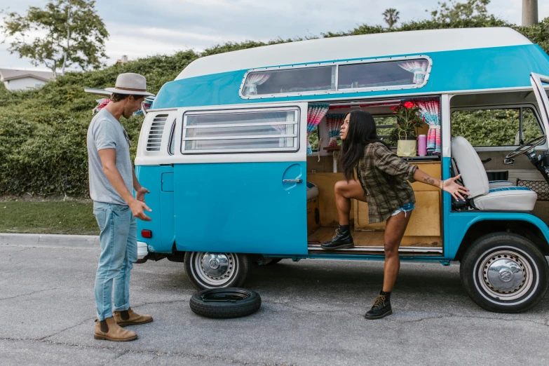 two people looking in the window of an old style bus