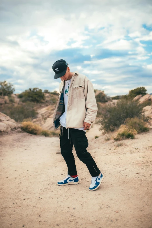 a man in a hat and jacket is walking